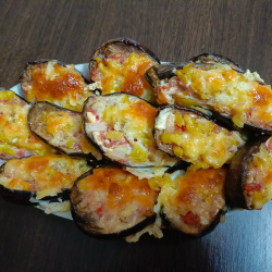  Половинки баклажанов с перцем, луком, помидором и сыром